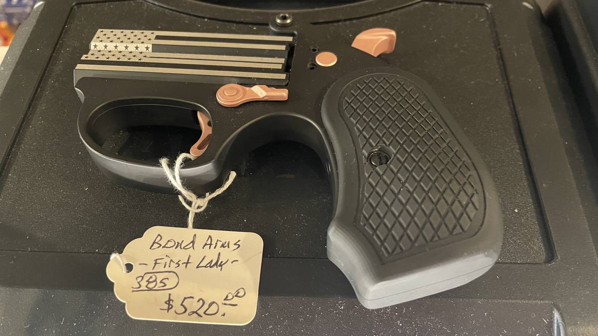 Bond Arms First Lady derringer in .380 with black finish, copper-toned controls, and American flag laser-engraved on the slide.