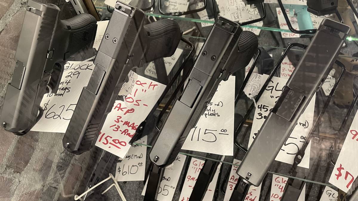 Glock pistol display case at Guns and Glory in Le Roy, Illinois — Glock 29 in 10mm, Glock 21 .45 ACP, Glock 22 Gen4, and Glock 41.