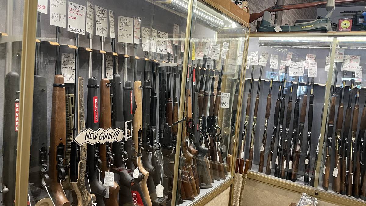 Rimfire and rifle wall: Ruger 10/22 Grizzly, 75th Anniversary Edition, Takedown, and Tactical, Rossi RB22, Kel-Tec Sub 2000, Henry Golden Boy lever actions, and Keystone Crickett youth rifle.